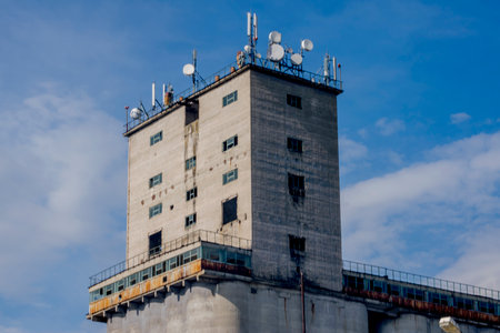 Abandoned high-rise building with antennas against the blue skyの写真素材