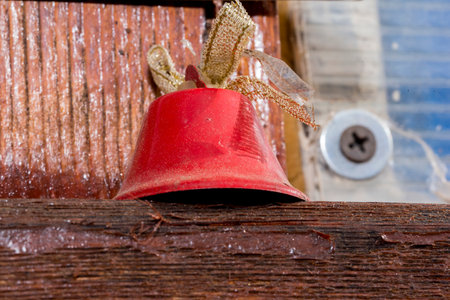 Christmas bell on the background of the old wooden wall, closeupの写真素材