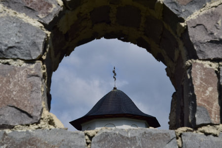 View through the window of an old castle with a tower in the foregroundの写真素材