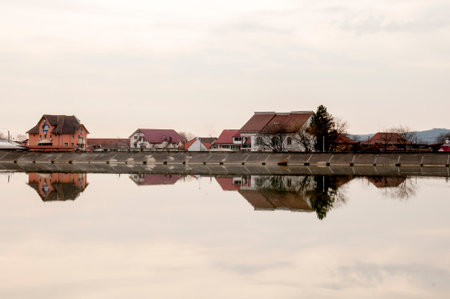 Reflection in the water of a small village on the shore of the lakeの写真素材