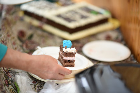 Chocolate cake with blue frosting in the hands of a woman