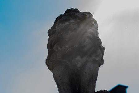 Statue of a lion on a background of the blue sky.の写真素材