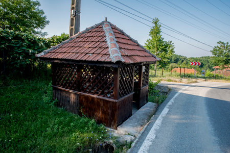 Wooden hut on the road in the village of Riga, Latviaの写真素材