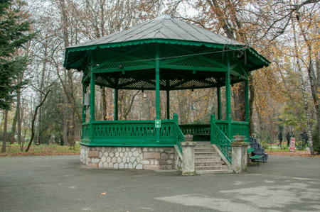 Wooden gazebo in the park in autumn.