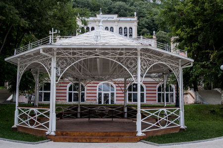 White gazebo at the entrance to the park in summerの写真素材