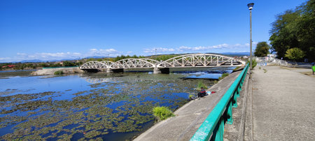 Panoramic view of the old bridge over the river on a sunny dayの写真素材