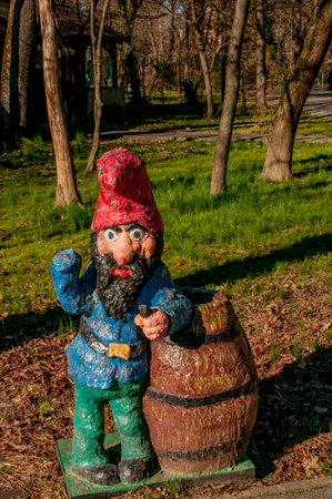 Garden gnome with a barrel of wine in the park.の写真素材