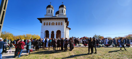 Unidentified people visit the Church of St. John the Baptist in Novaci Romania