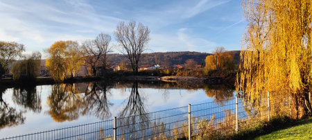 Panoramic view of the river and the city park in autumn