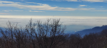 Mountain landscape with fog and blue sky. Panoramic view.