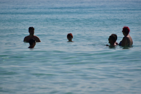 Group of people swimming in the sea on a sunny day. Summer vacation.の写真素材