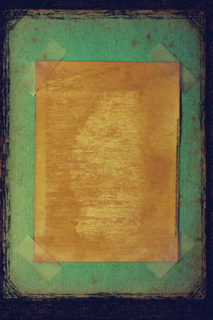 Old grungy vintage frame with tapeの写真素材