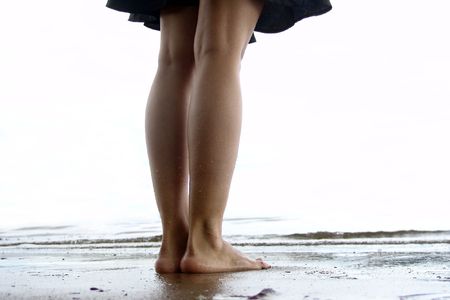 Girl's legs with waterdrops. Seaside.                               の写真素材