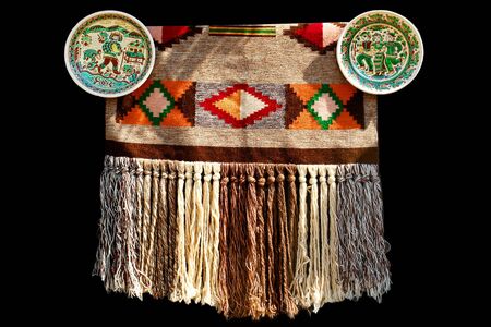 Traditional ukrainian carpet with two plates. Hand-made. Isolated on black.                         ...