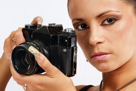 Sexy girl with slr photo camera taking a shoot.