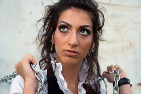 Pretty long - haired armenian girl with chains.の写真素材