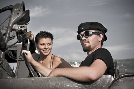 Portrait of beautiul couple in a retro car.の写真素材