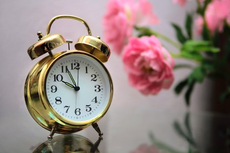 Retro-styled alarm clock on the fuzzy grey background