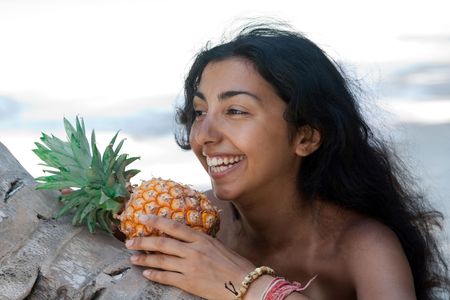 Portrait of a beautiful girl with the fresh pineappleの写真素材