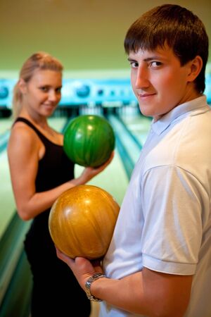 Pretty couple with two color bowling ballsの写真素材