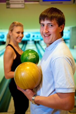 Pretty couple with two color bowling ballsの写真素材