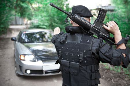 Warrior with the M4 rifle is stopping the car on the roadblockの写真素材