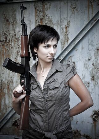 Portrait of a woman with the machine gun.の写真素材