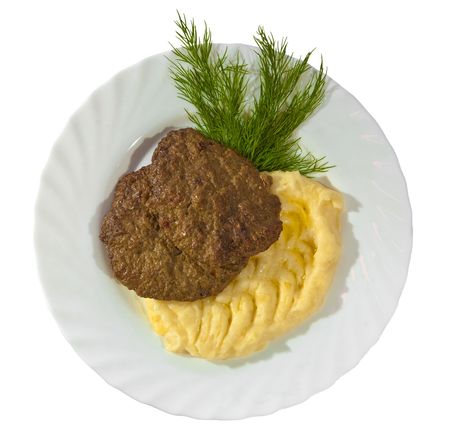 Tasty mashed potato with meat rissole served with dill. Isolated on white background..