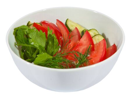 Green salad with tomato and cucumber served with dill and parsley. Isolated on white.の写真素材