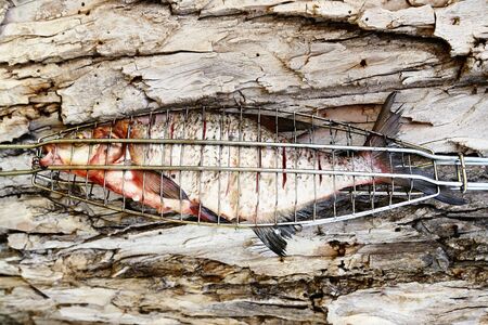 Grilled fish on the wooden cork background.の写真素材