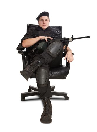 Sitting soldier with the machine gun. Isolated on white.の写真素材
