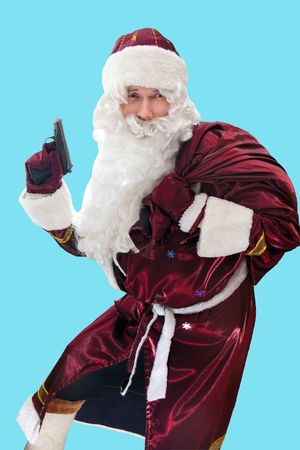 Santa with the gun and sac isolated on blue.の写真素材