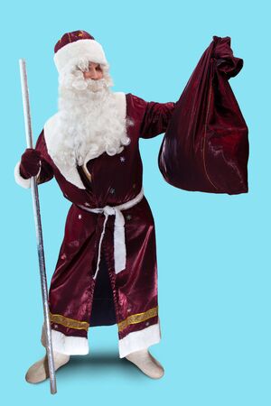 Santa with the big sac full of presents. Isolated on blue.の写真素材