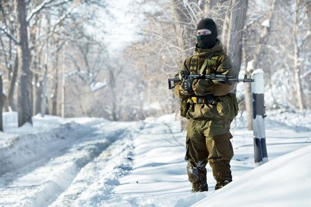 Russian soldier in winter uniform with the machine gun on the forest background.の写真素材