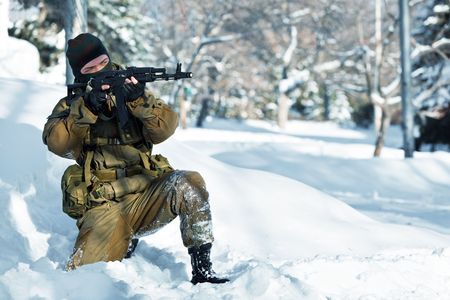 Russian soldier in winter uniform with the machine gun on the forest background.の写真素材
