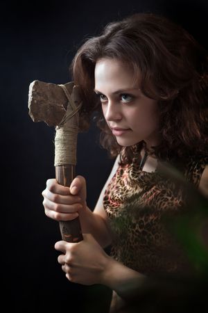 Prehistoric woman with the stone axe. の写真素材