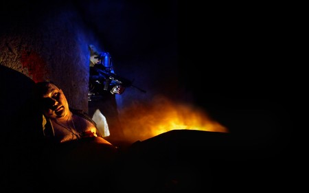 Bloody zombie in the dark. Soldier with the rifle in the gas mask on the backgroundの写真素材