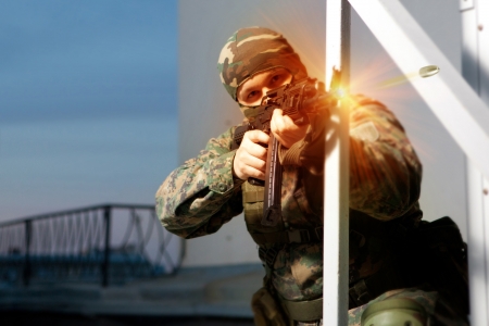 Special squad soldier is shooting from the  machine gun.の写真素材