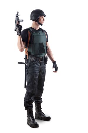 Police officer in body armour is holding a gun. Isolated on white.の写真素材