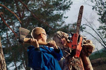 Woman fights with the maniac, axe against chainsawの写真素材