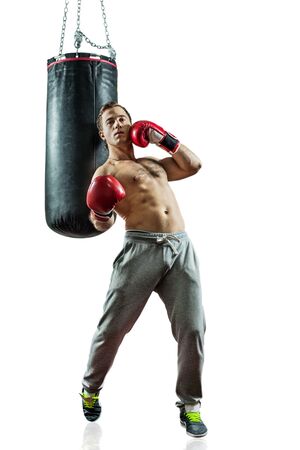 Muscular boxer near the boxing bag. Isolated on white background.の写真素材