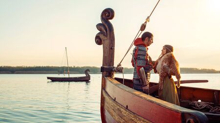 Couple of North princess and her beloved warrior on the bow of the sailboat.の写真素材