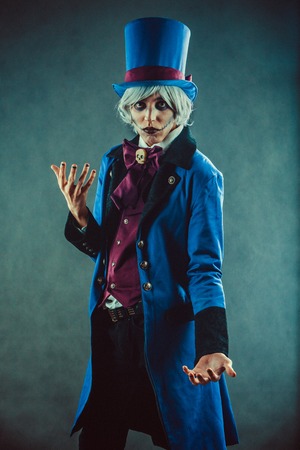 Sad gesticulating circus actor in blue tuxedo.の写真素材