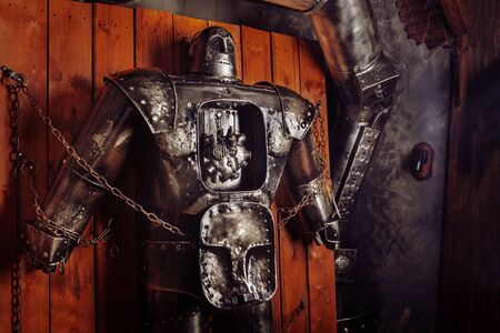 Huge retro robot with the naked heart chained in the laboratory.の写真素材