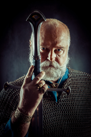Portrait of praying Templar knight on a dark background.の写真素材