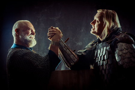 Medieval knights have a hard arm wrestling matchの写真素材