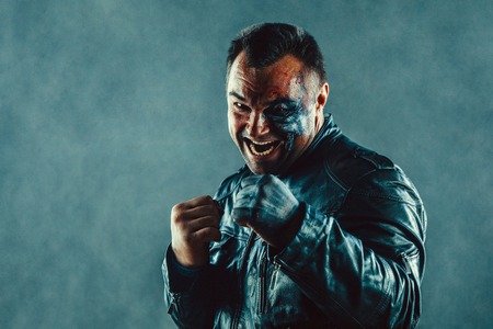 Dangerous powerful man with scares and burns on the face.の写真素材