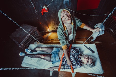 Maniac with the blade is going to kill the blond girl.の写真素材