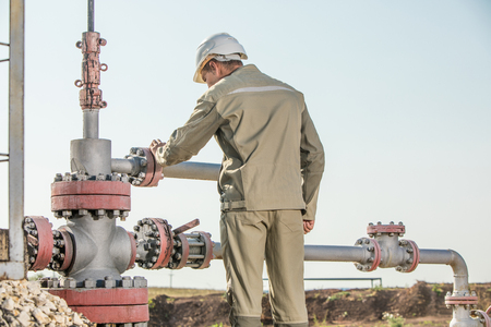 Oil worker is checking the oil pump.の写真素材