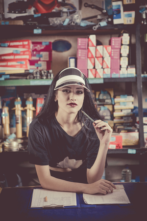 Smiling saleswoman at the counter in the autoparts shop.の写真素材